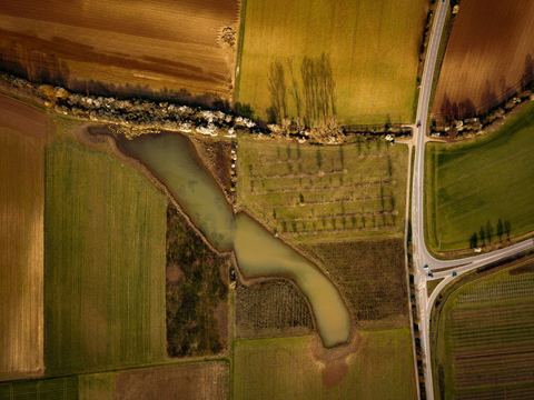 Aerial view of farmland and a pond