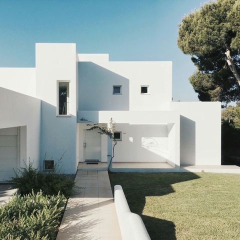 White contemporary house with a landscaped garden path